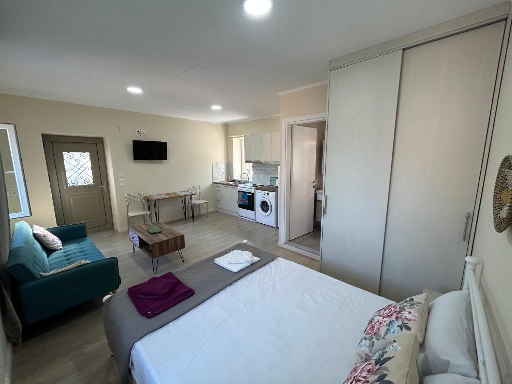 a bedroom with a bed and a living room at Anmare Studios in Nydri