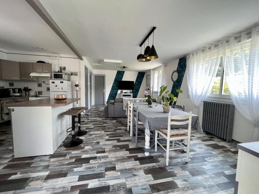 a kitchen and living room with a table and chairs at Maison avec jardin centre ville in Saint Lo