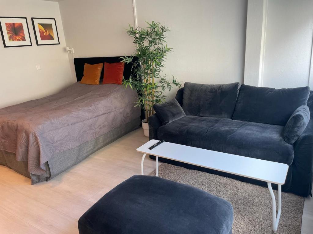a living room with a couch and a bed at Cozy apartment in the middle of Bergen city center in Bergen