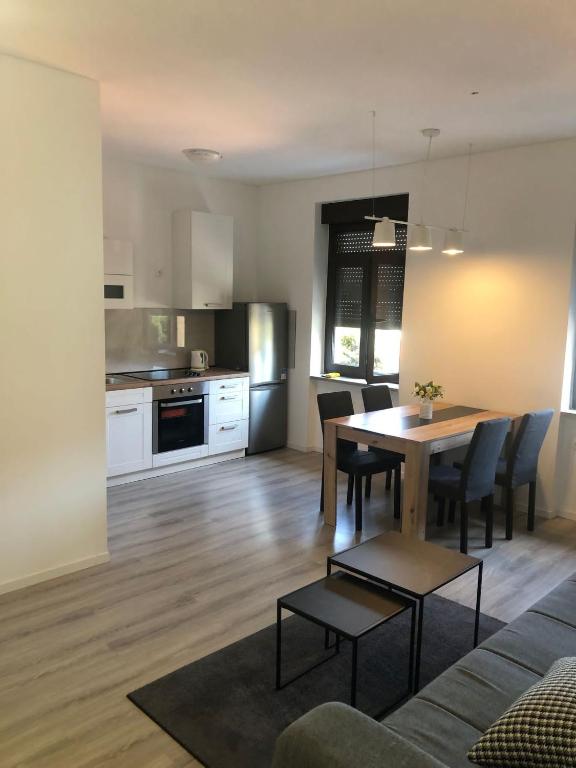 a living room and kitchen with a table and chairs at Apartment Centro 2 in Kastav