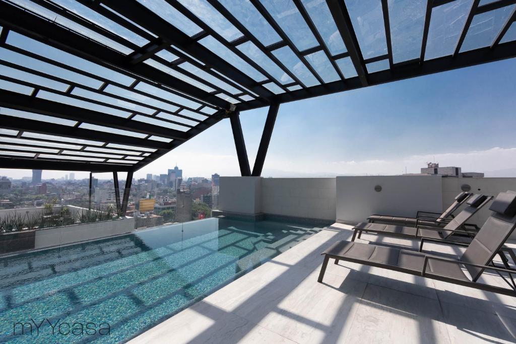 a swimming pool on the roof of a building at Private Balcony Infinity Pool & Rooftop in La Roma - Queretaro in Mexico City