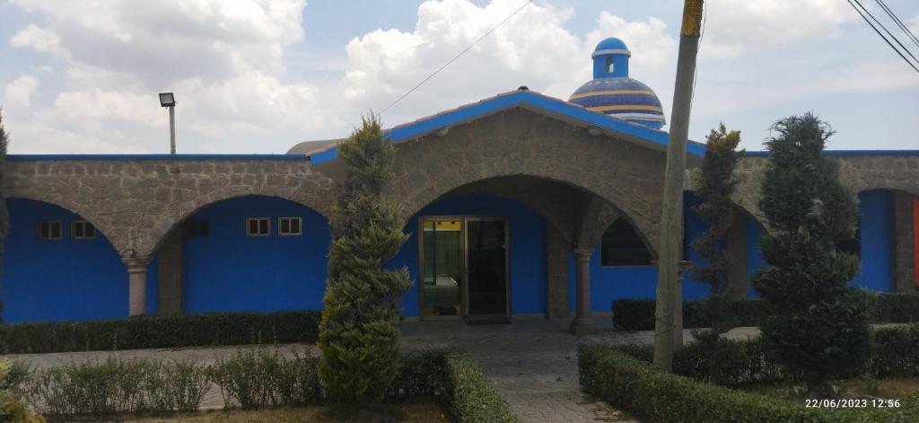 a blue building with a dome on top of it at Hotel Sevilla Perote in Perote