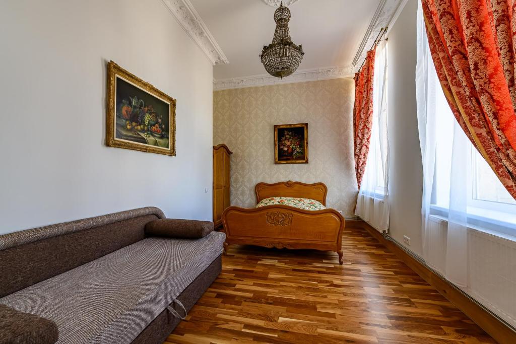 a living room with a couch and a window at Teatrum in Liepāja