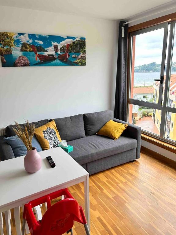 a living room with a couch and a table at Playa Miño in Miño