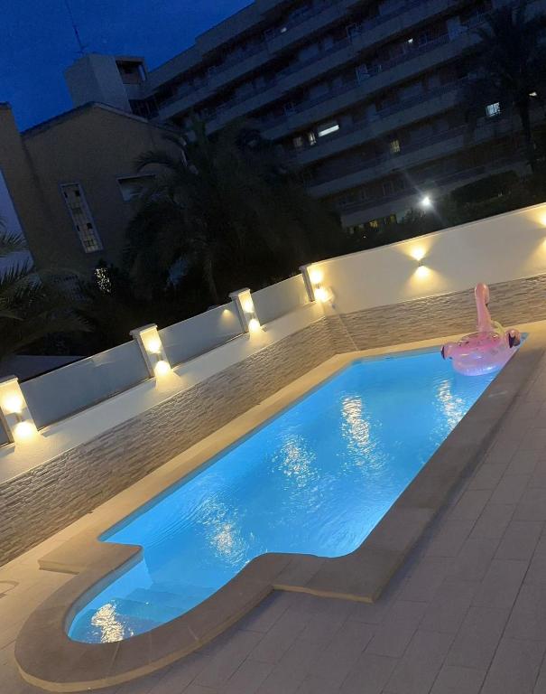 a swimming pool at night with a person in a float at Luxury Private New 2023 Villa Mirelle in Torrevieja