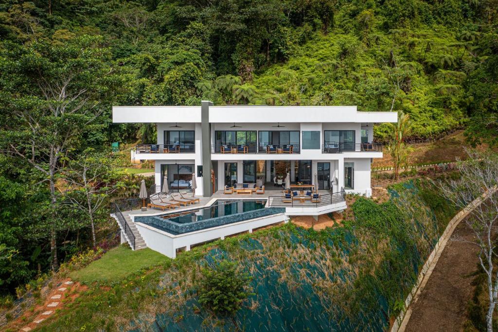 an aerial view of a house with a swimming pool at Amigos Por La Vida in Dominical