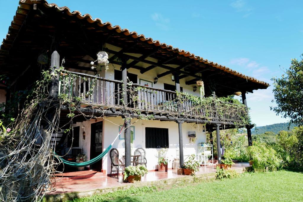 a large white house with a balcony at Hotel Anacaona in San Agustín