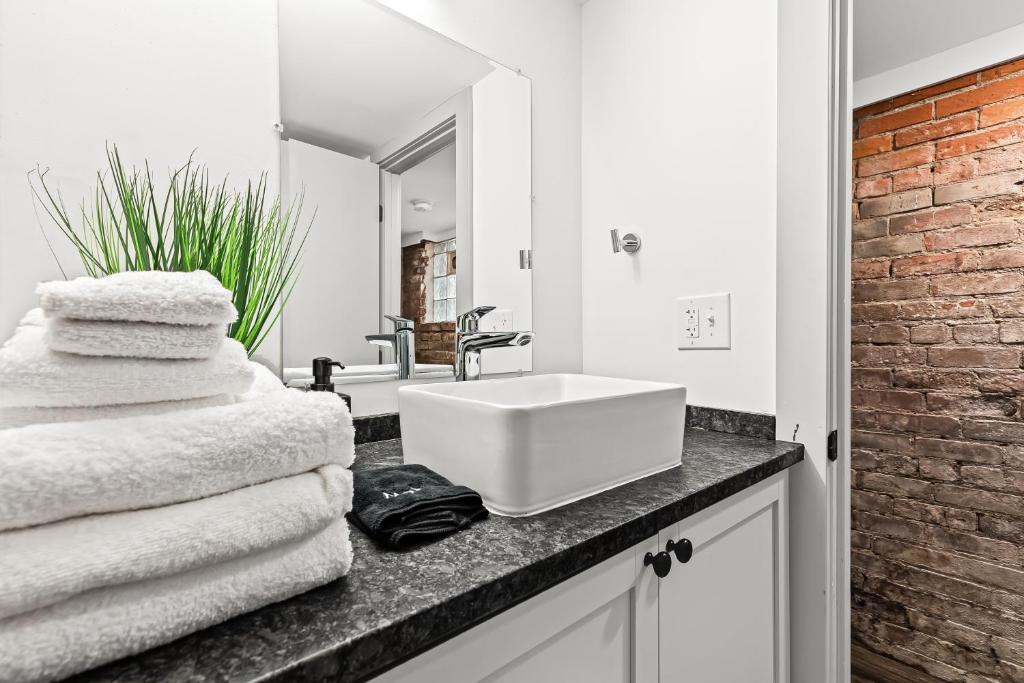 a bathroom with a sink and towels on a counter at The Midtown Hideaway in Detroit