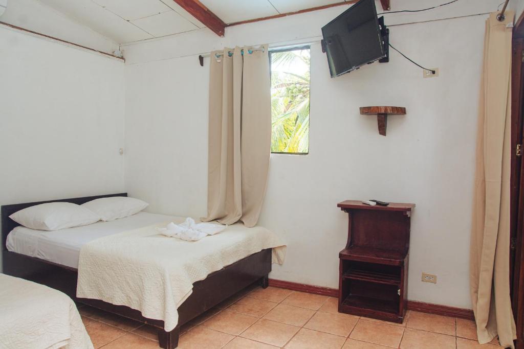 Postel nebo postele na pokoji v ubytování Arrecife Punta Uva - Hospedaje, bar y restaurante - Frente al mar
