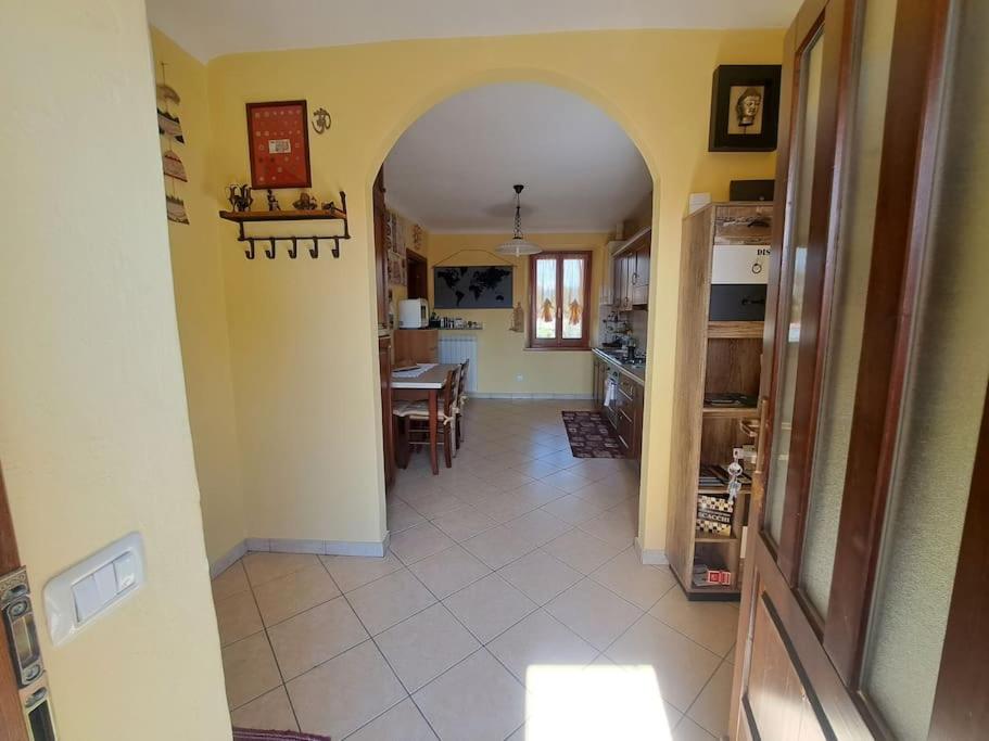 a kitchen and dining room with an archway in a house at Casa Poldo in Cantello