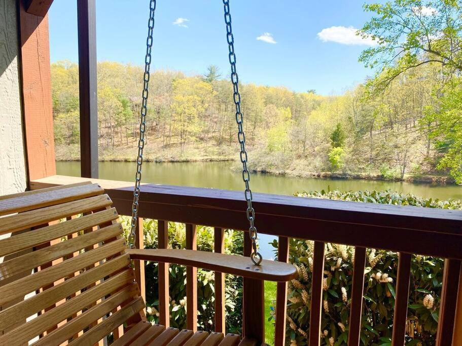 a swing on a porch with a view of a river at Lakeside Retreat Free Golf Swim Tennis in Hedgesville