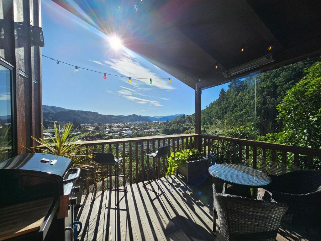 a balcony with a table and chairs and a view at Garden View Cottages in Picton