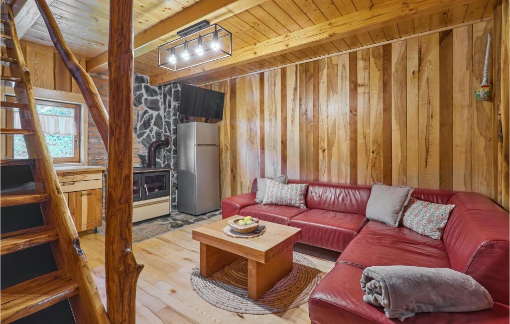 a living room with a red couch and a table at Beautiful Home In Kraljev Vrh With Wifi in Kraljev Vrh
