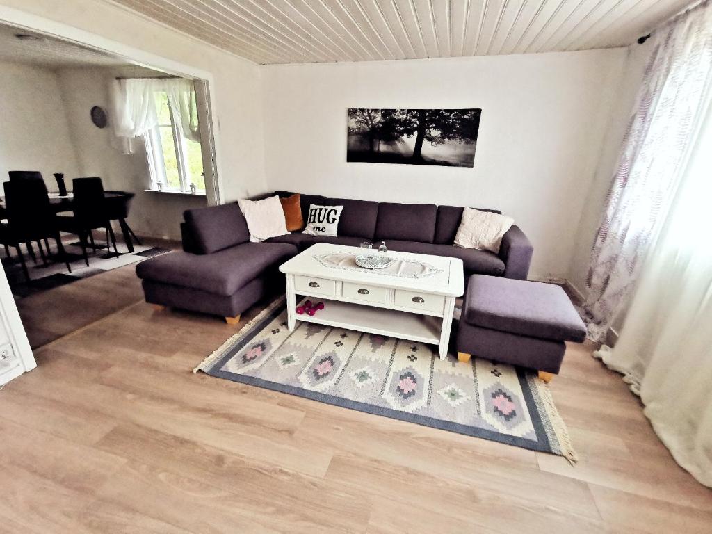 a living room with a couch and a table at GolfHuset 