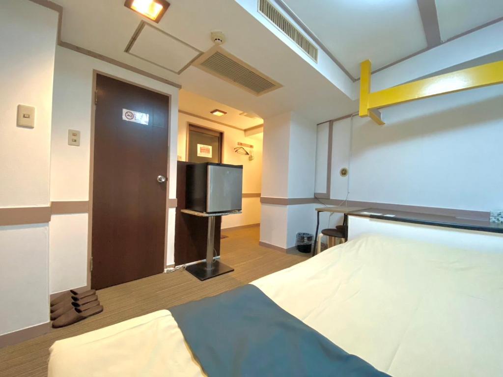 Postel nebo postele na pokoji v ubytování Tabist Hotel Florida Ikebukuro