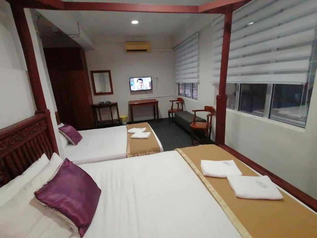 Postel nebo postele na pokoji v ubytování Mi Hotel 2 Dungun