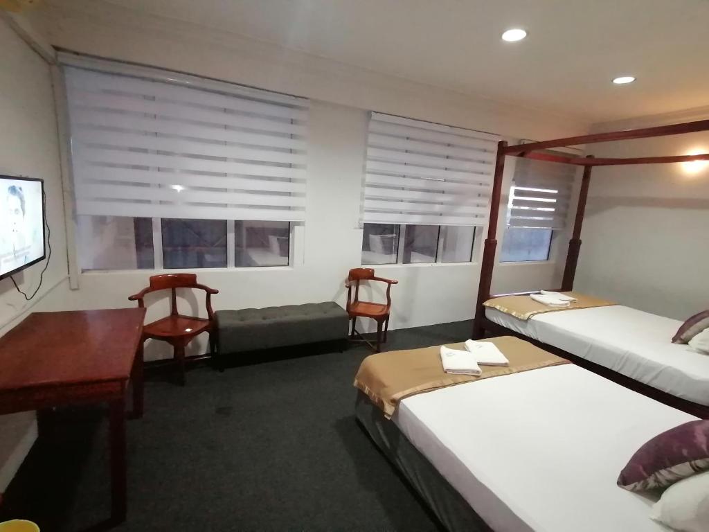 Postel nebo postele na pokoji v ubytování Mi Hotel 2 Dungun