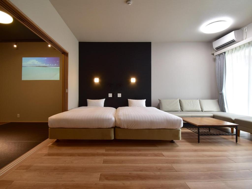 a bedroom with a bed and a couch at Rakuten STAY MOTEL Kujukurihama Katakai 101 1LDK with BBQ terrace pet allowed in Kujukuri