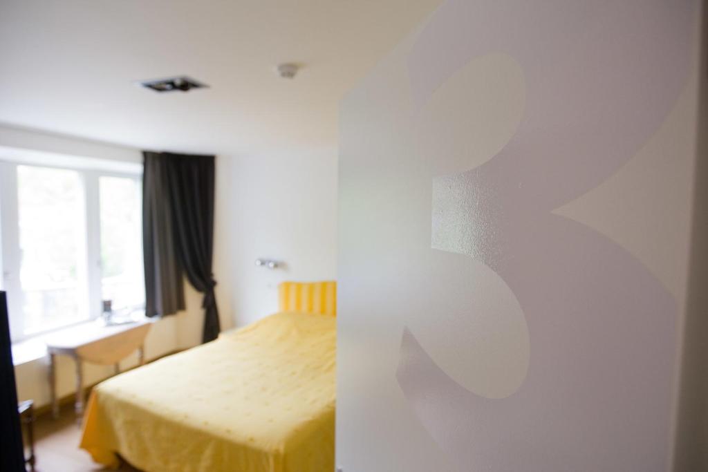 Postel nebo postele na pokoji v ubytování Hotel Le Clos des Récollets