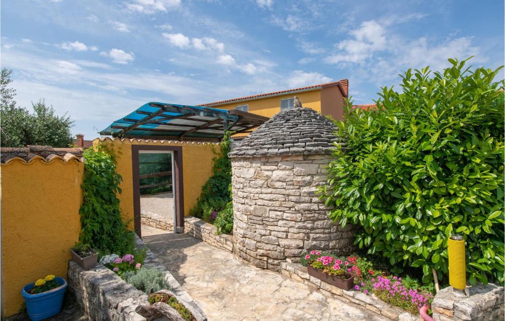 a house with a stone wall and a blue roof at Pet Friendly Home In Krnica With Wifi in Krnica