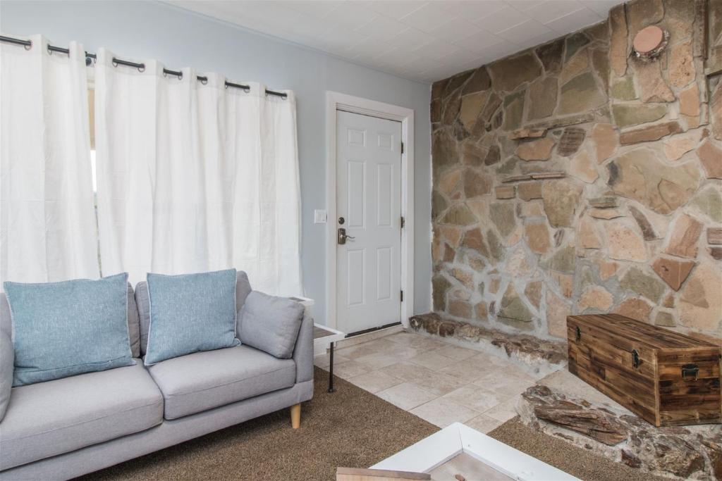 a living room with a couch and a stone wall at Casa Azul in Panguitch