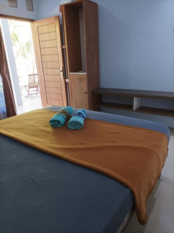 Postel nebo postele na pokoji v ubytování Merendeng Hostel Kuta