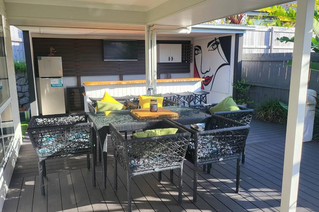 a patio with a table and chairs on a deck at Sunny Coast Getaway in Bli Bli