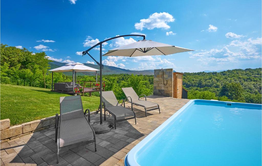 a swimming pool with chairs and an umbrella at Beautiful Home In Kraljev Vrh With Wifi in Kraljev Vrh