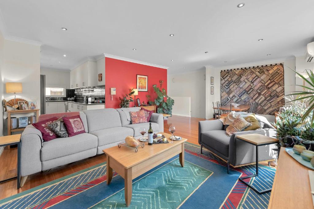 a living room with a couch and a table at StayCentral - Tranquil Spacious Townhouse in Melbourne