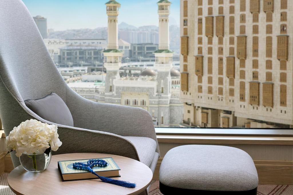 Habitación con silla, mesa y ventana en Jumeirah Jabal Omar Makkah en La Meca