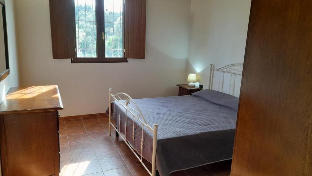 Habitación pequeña con cama y ventana en Villa Paradiso, en Montegiordano