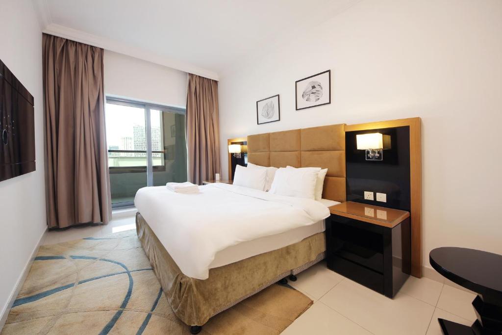 a hotel room with a large bed and a window at SHH - Spacious 2 Bedroom Apartment in Capital Bay Tower B, Business Bay in Dubai