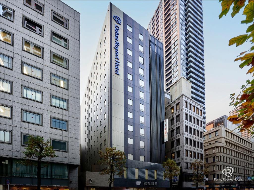 two tall buildings in a city at Daiwa Roynet Hotel Osaka-Kitahama in Osaka