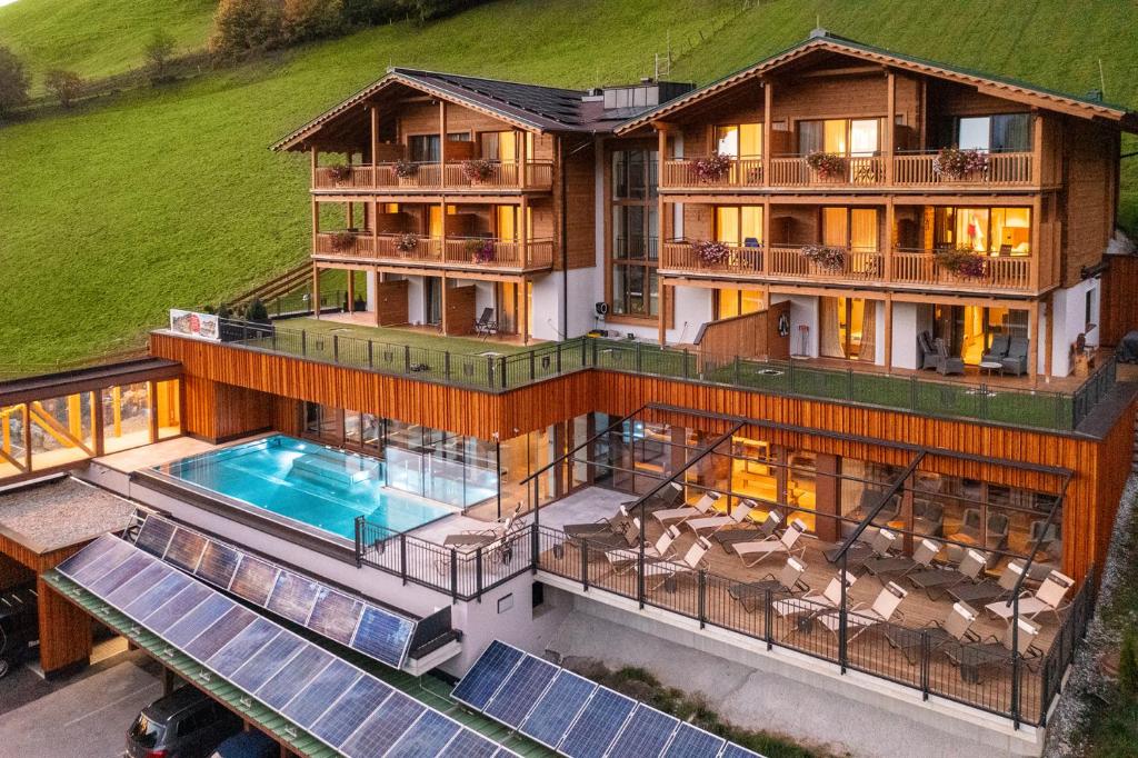an aerial view of a house with a swimming pool at Berghotel Hauserbauer in Dorfgastein