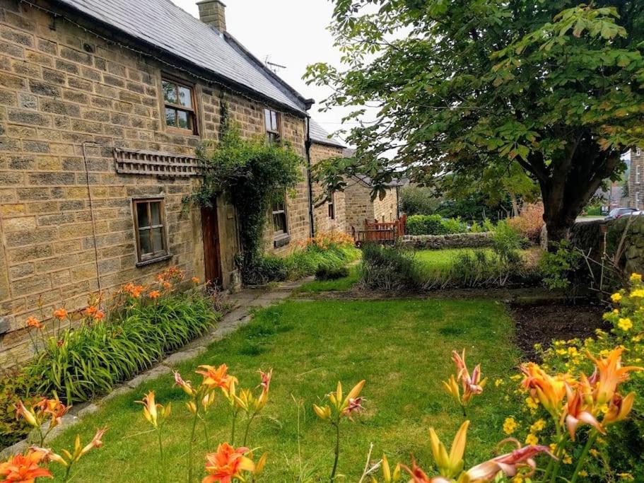 a garden in front of a brick house at Church Farm Cottage Fritchley in Crich