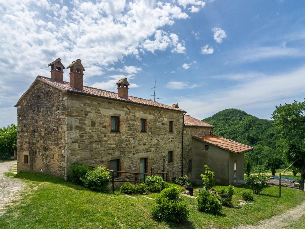 an old stone house with two chimneys on top of it at Beautiful Apartment in Sestino with Garden in Sestino