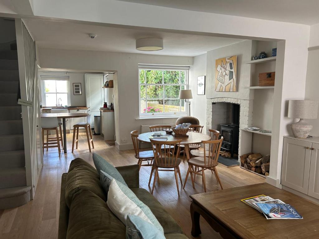 a living room with a couch and a table at Billie's seaside retreat in Lyme Regis