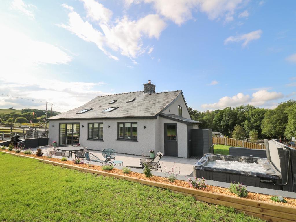 a house with a hot tub in the backyard at Rhiwmynach in Aberystwyth