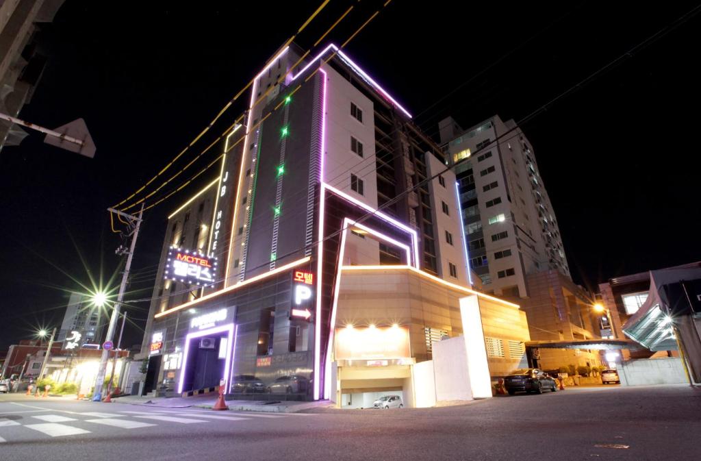 a building with lights on the side of it at night at Palace Hotel in Ulsan