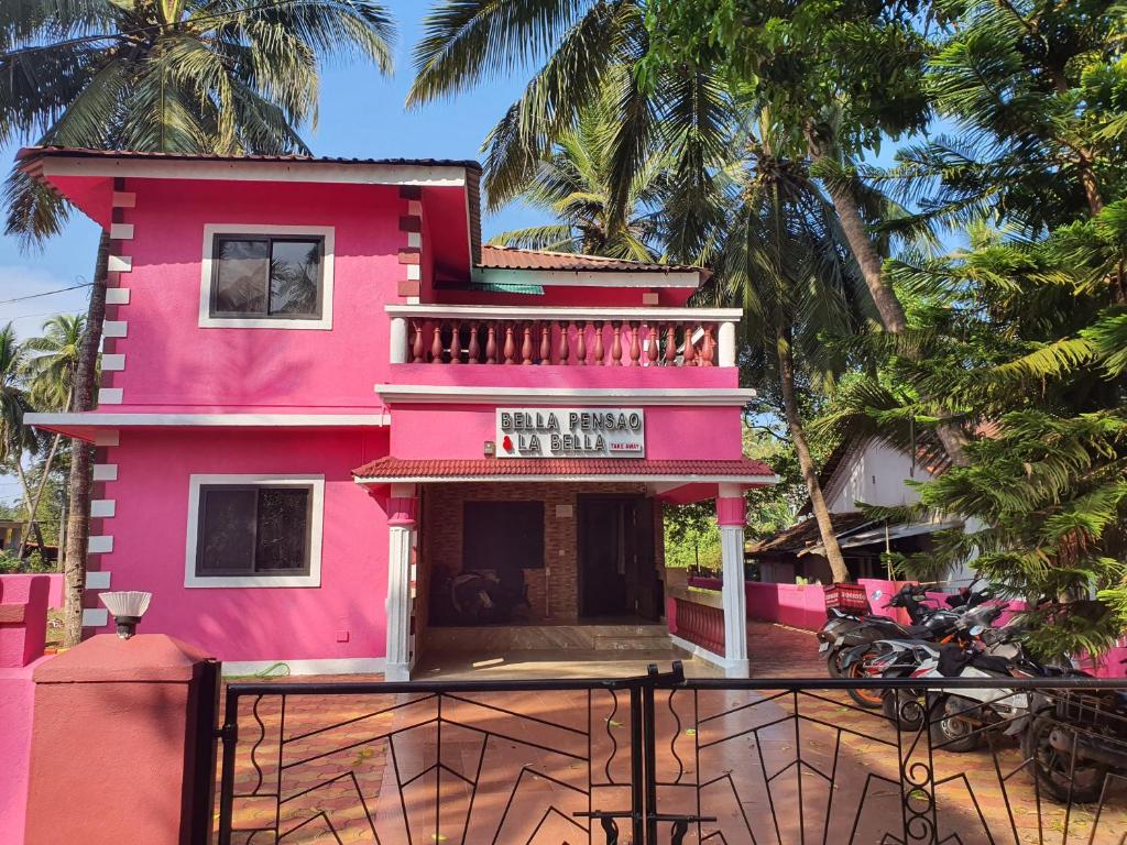 a pink building with a sign on it at Bella Pensao in Parra