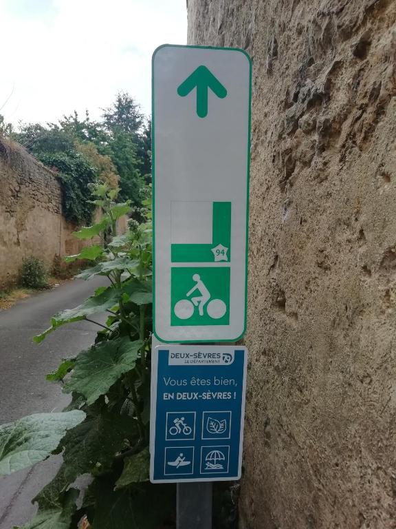 a street sign with a person riding a bike at Thunder Roadhouse in La Mothe-Saint-Héray
