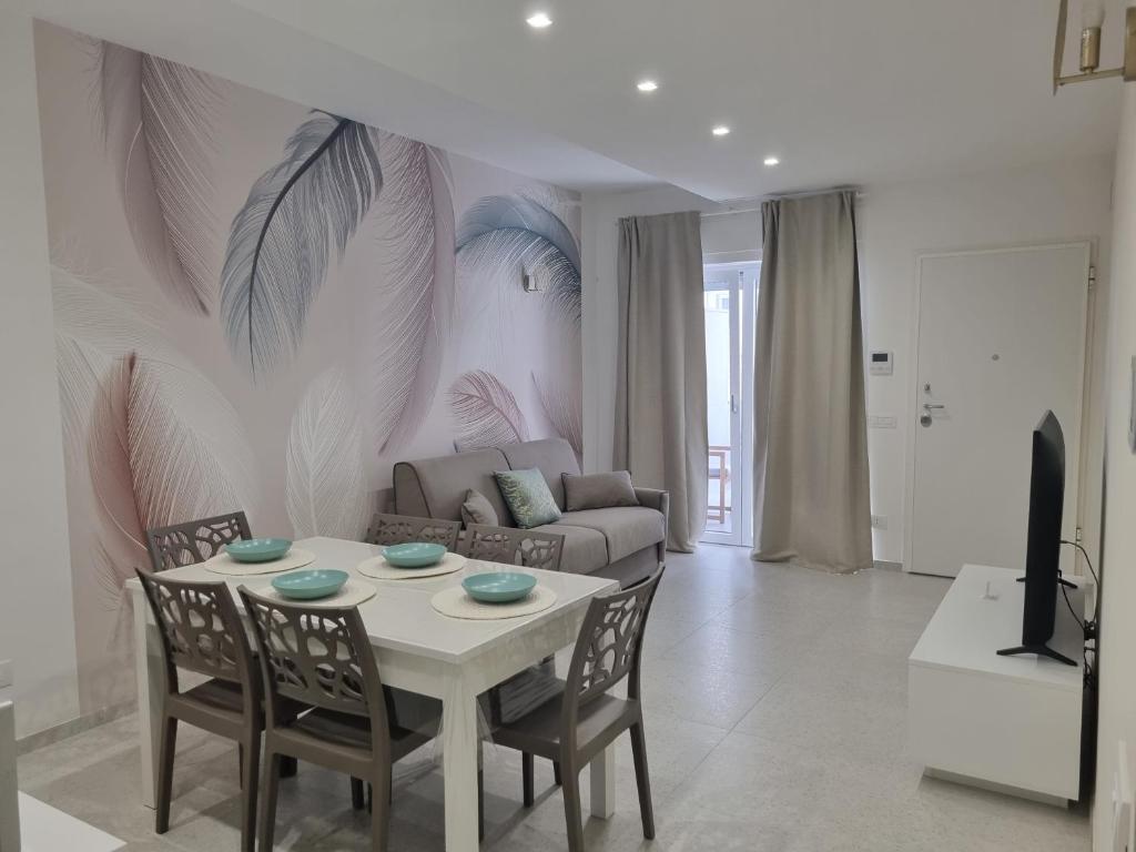 a living room with a table and a couch at La Casa di Mimi in Monopoli