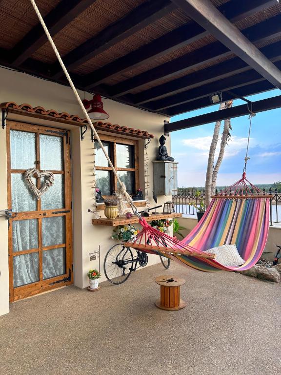 a hammock on a porch of a house at Sotira Agia Napa Luxury House in Ayia Napa