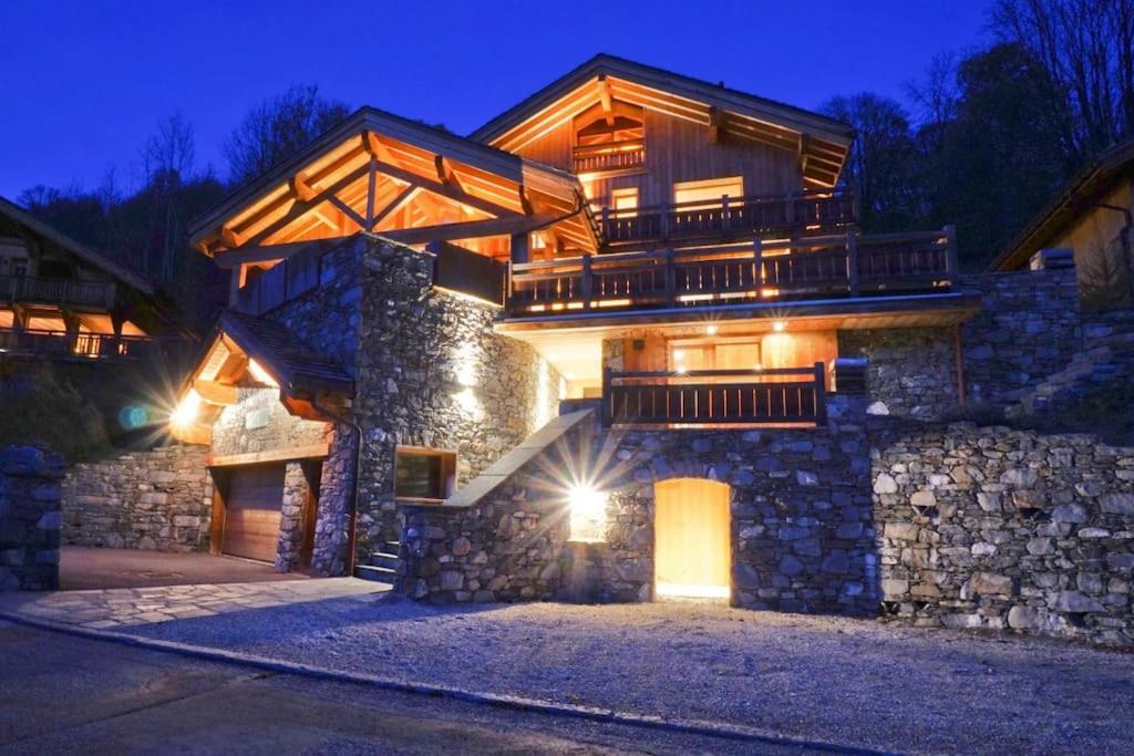 a large house with a balcony on top of it at Chalet Kalliste spacieux Meribel 5 min des pistes avec Spa in Les Allues