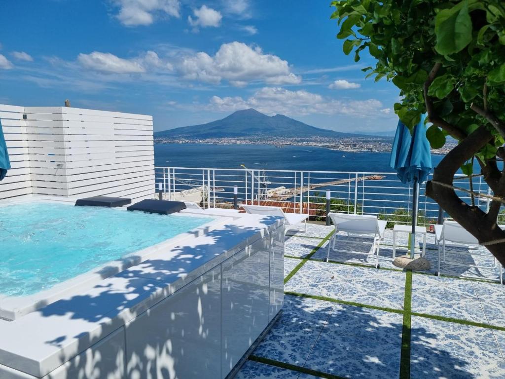 a pool on the roof of a building with a view of the ocean at Relais al Castello in Castellammare di Stabia