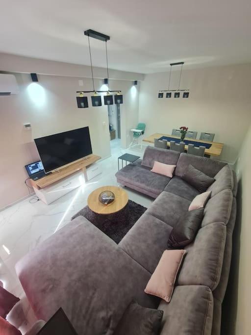a living room with a couch and a flat screen tv at Mias luxury apartment in Rijeka