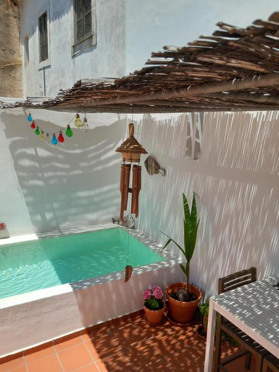 a patio with a swimming pool in a house at Casa da Umbria in Odemira