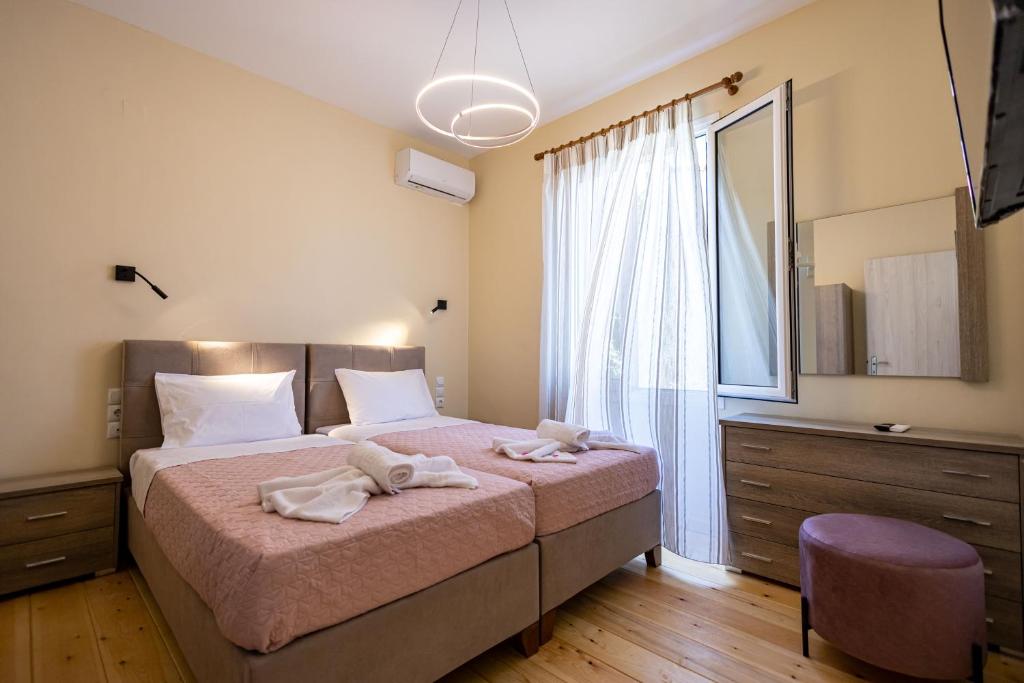 a bedroom with a large bed with towels on it at Villa Saitan Bazaar in Preveza