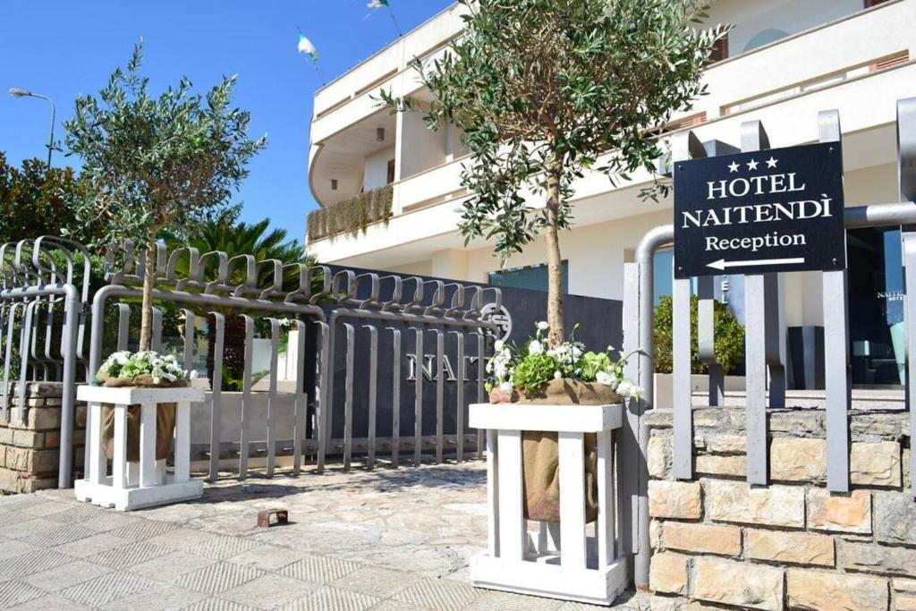 a fence with a sign in front of a hotel meridian reception at Hotel Naitendì in Cutrofiano