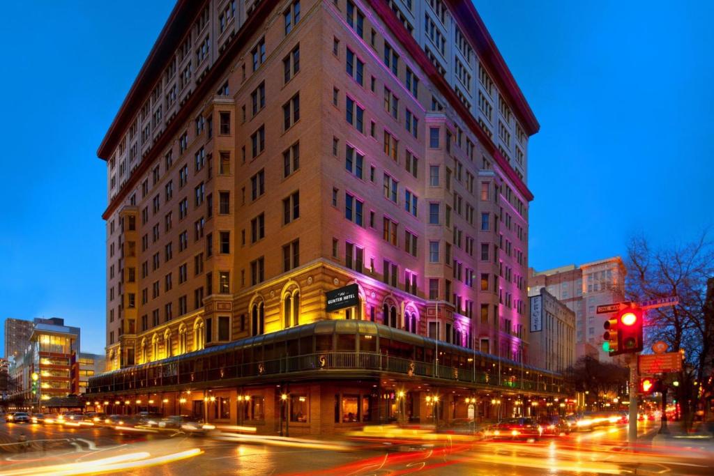 a large building on a city street at night at The Gunter Hotel San Antonio Riverwalk in San Antonio